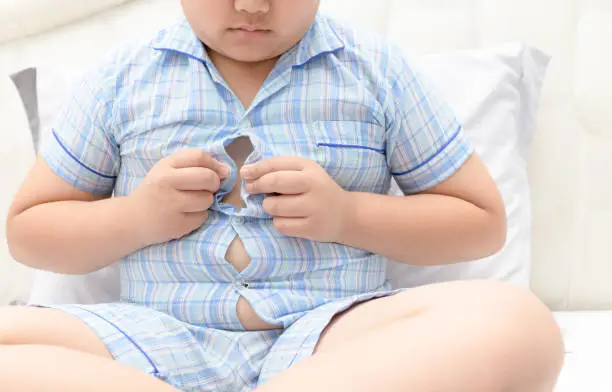 boy overweight. Tight shirt of pajamas, healthy concept