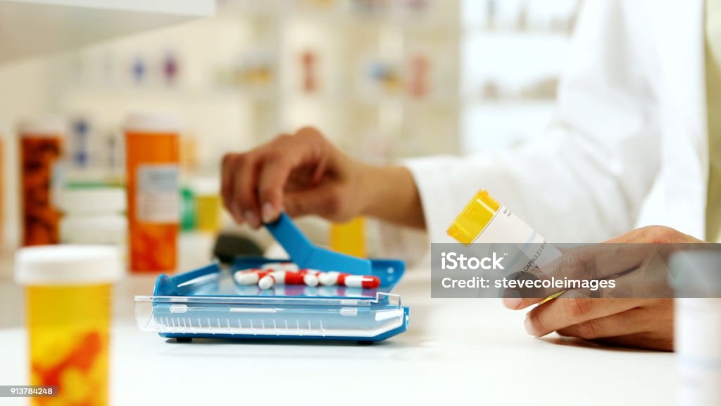 Pharmacist filling Prescription Pharmacist Stock Photo