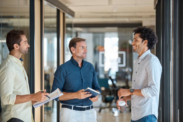 istock Businessmen discussing in office corridor 913784352