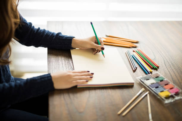 istock Artist sketching at her work desk 913785790
