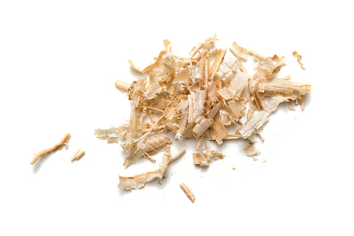 Wood shavings isolated on white background. Wooden shaving at brown