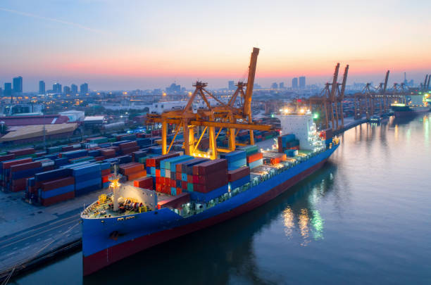 istock Containers yard in port congestion with ship vessels are loading and discharging operations of the transportation in international port.Shot from drone. 913786836