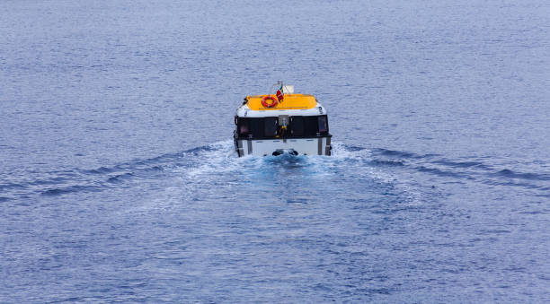 istock Yellow and White Lifeboat Cutting Through Blue Water 913800498