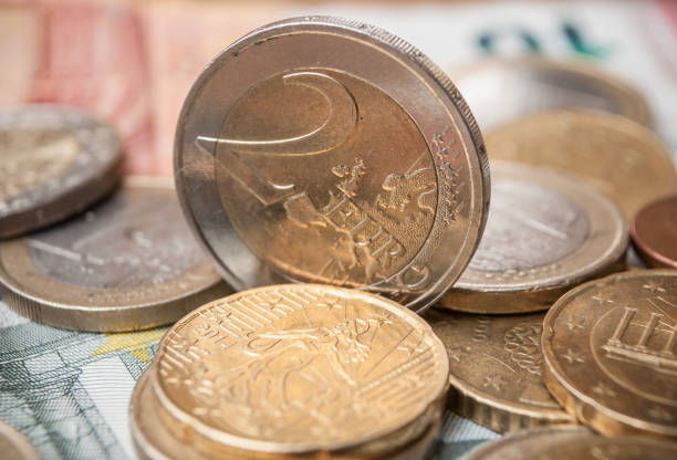 istock euro coins and bank notes on wooden table background 913800856