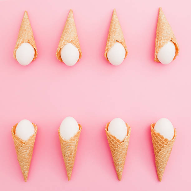 istock Stylish frame made of Easter white eggs in waffle cone on pastel pink background. Top view, Flat lay. Easter holiday concept. 913801186