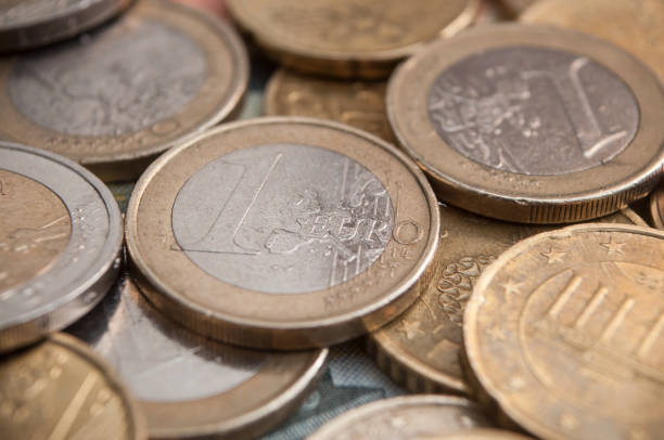 istock euro coins and bank notes on wooden table background 913804662