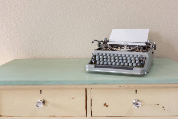 1950's antique typewriter with blank white paper and copy space. Front view.