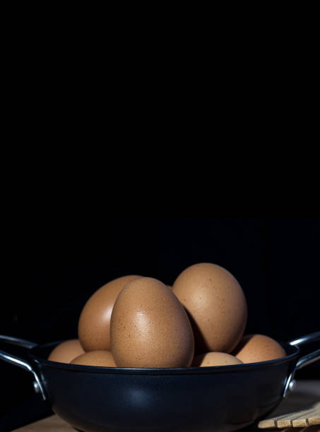istock Still Life Organic Eggs in Metal Pan on the Dark Background 913808088