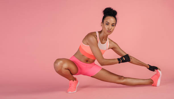 istock Healthy woman doing stretching exercises in studio. 913808902