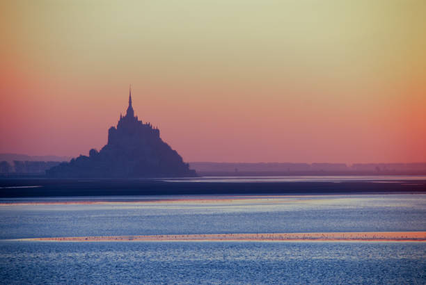 Sunset over Mont Saint-Michel ,Normandy,France Medieval abbey located on a rocky island with very strong tides.  Unesco World Heritage Site. mont saint michel photos stock pictures, royalty-free photos & images