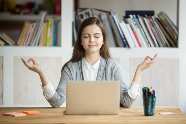 calm relaxed woman meditating with laptop, no stress at work - yoga business women indoors imagens e fotografias de stock