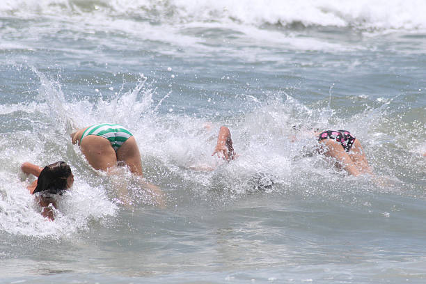 Body Surfing backside for a girl on the beach stock pictures, royalty-free photos & images