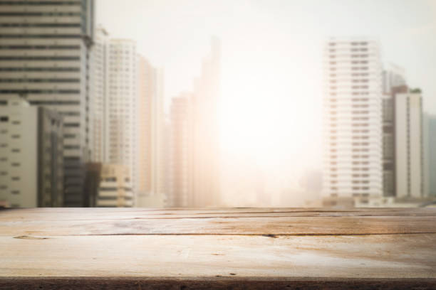istock Blurred background of sunset city and desk space. 913820280
