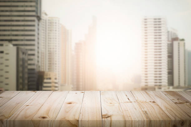 istock Blurred background of sunset city and desk space. 913820294