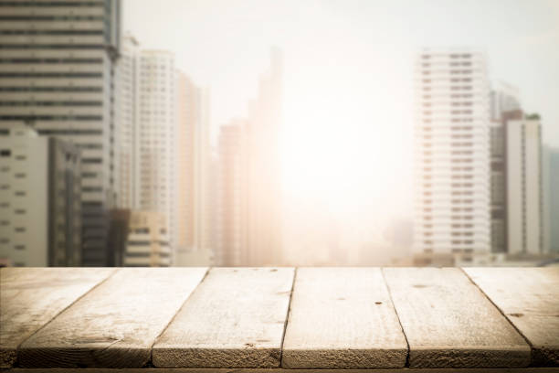 istock Blurred background of sunset city and desk space. 913822584