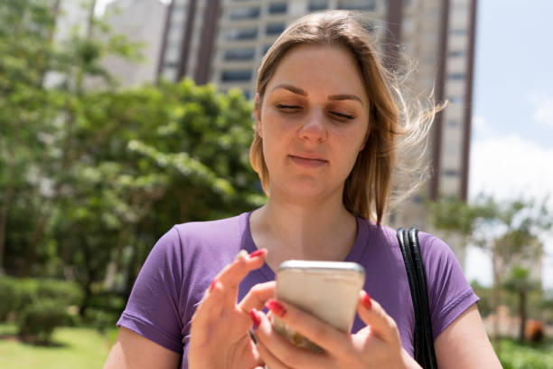 istock Young woman using her smartphone 913824186