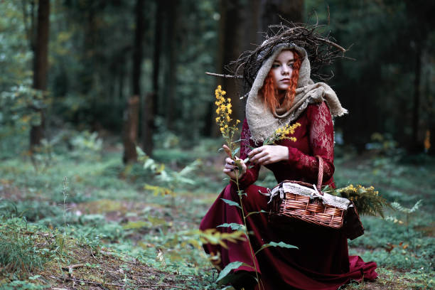 istock The red-haired witch holds a ritual with a crystal ball 913824582