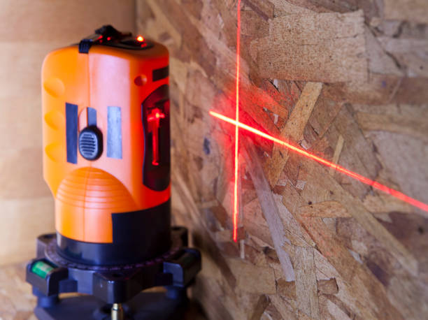 laser measurement level for construction works, small depth of sharpness, focus on a wall with a tag stock photo