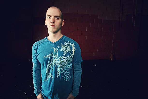 istock Young Male in Blue Shirt Against Red Wall 91383427