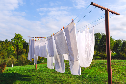 fresh clean white sheet drying on washing line in outdoor