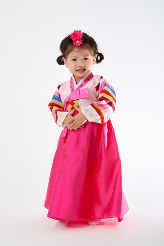 Smile Korean little girl wearing a Traditional Hanbok dress in white background