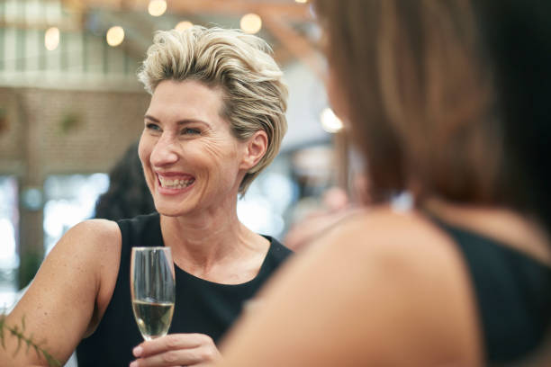 istock Elegant mature woman enjoying a drink after work 913840240