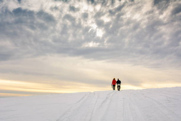 istock Couple hiking on the snow covered mountain 913840446