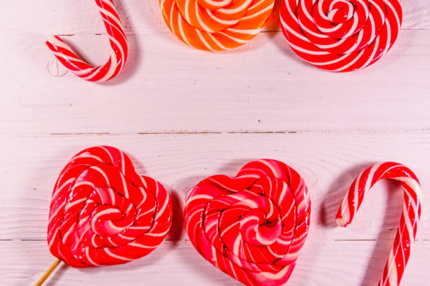 different sweet lollipops on a wooden table. top view - flavored ice variation birthday candy imagens e fotografias de stock