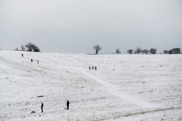istock Winter meadow with snow and people during winter. 913854948