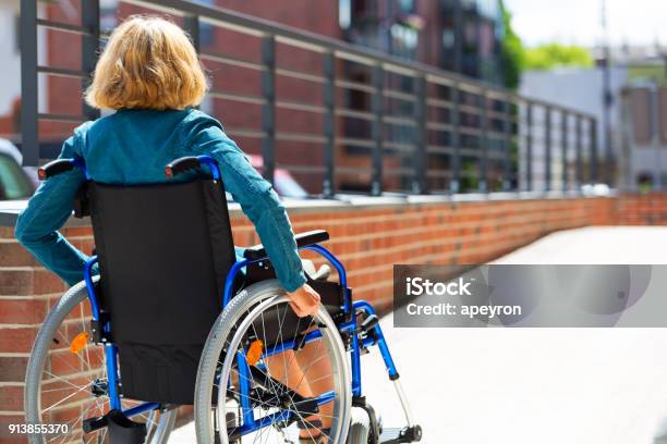 Woman On Wheelchair Entering The Platform Stock Photo - Download Image Now - Disability, Wheelchair, Accessibility