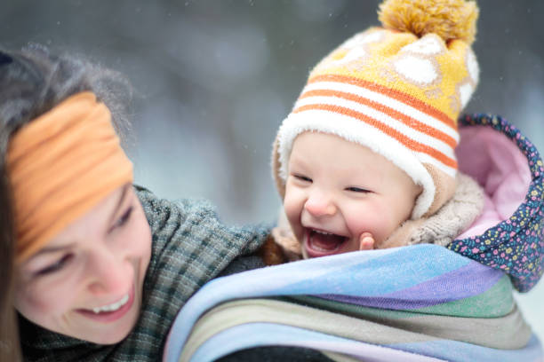 istock Young Mom with toddler in sling on her back 913858164