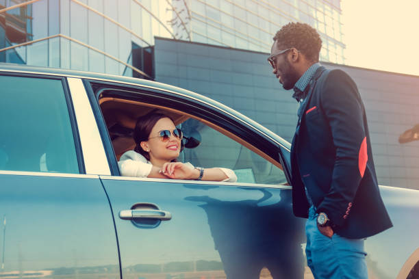 istock Casual couple posing near a car. 913859174