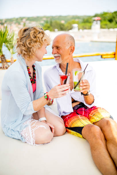 istock Senior Couple Drinking Coctails Together on Summer Vacations 913859570