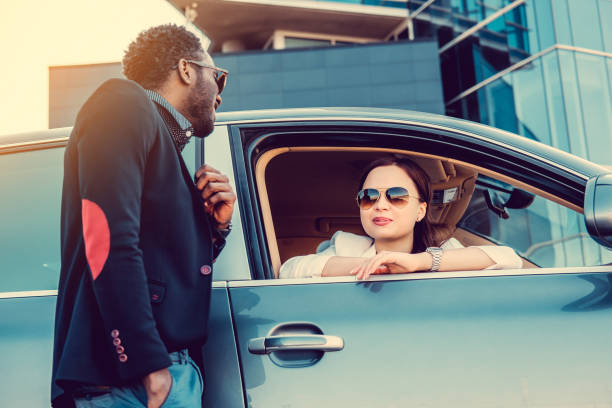 istock Casual couple posing near a car. 913861960