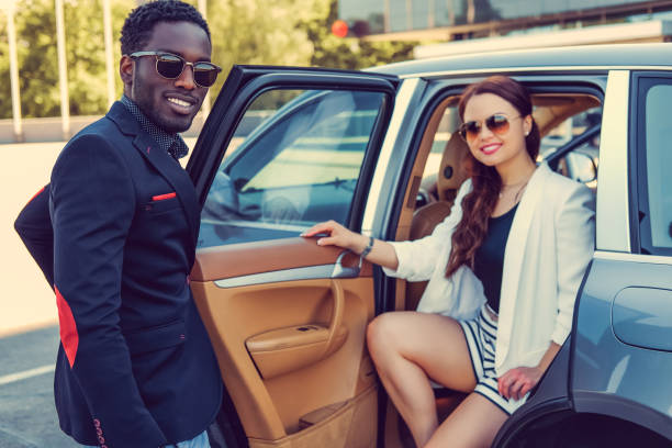 istock Casual couple posing near a car. 913865270