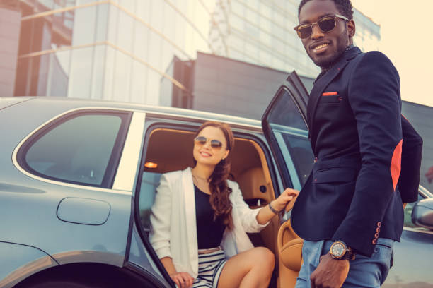 istock Casual couple posing near a car. 913865340