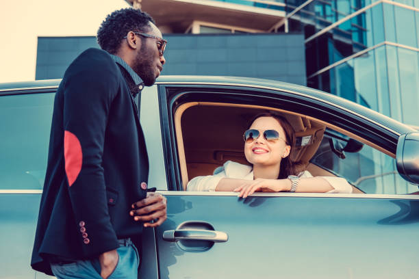 istock Casual couple posing near a car. 913865490