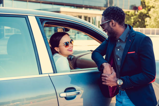 istock Casual couple posing near a car. 913865980