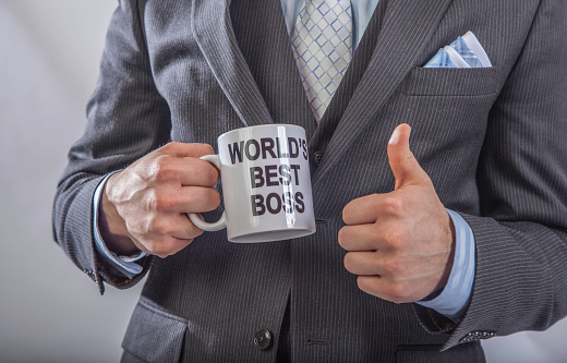Man holding worlds best boss mug