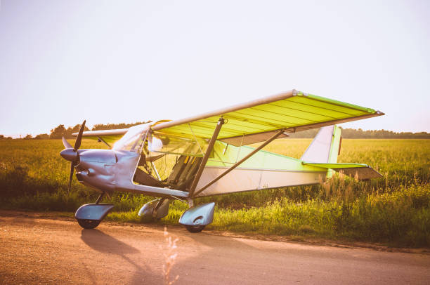 istock Small plane in the sky and on the field 913870300