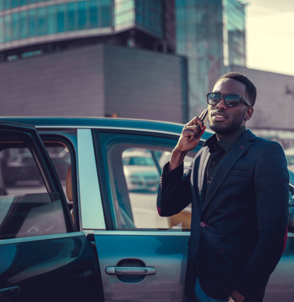 istock Black man in sunglasses talking by smartphone. 913870360