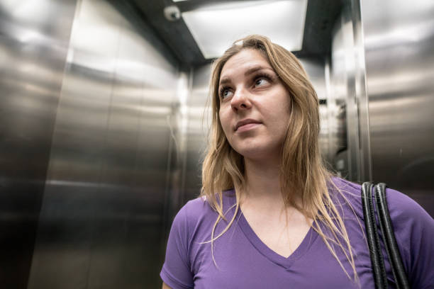 istock Young blonde woman inside the elevator 913872542