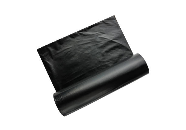 istock Packages for garbage on a white background. Roll of black plastic bags close-up. 913872628