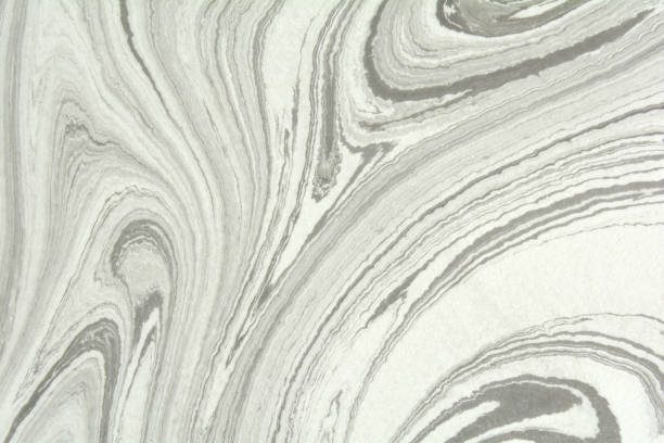 istock Mix of a white and black paint, closeup. Abstract marbling texture. Handmade ebru technique. 913873216