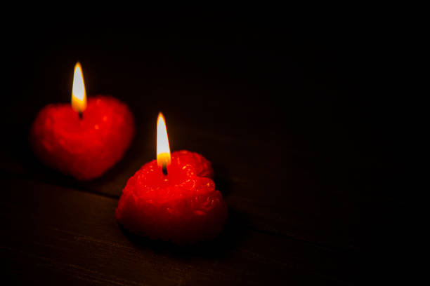 istock Heart shaped candles burning 913873454