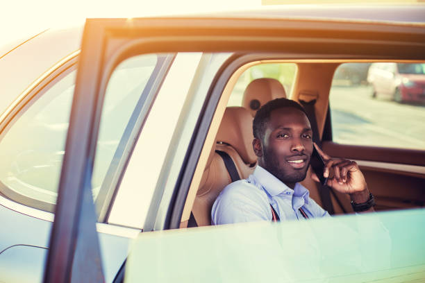 istock A black man with smartphone in a car. 913873652
