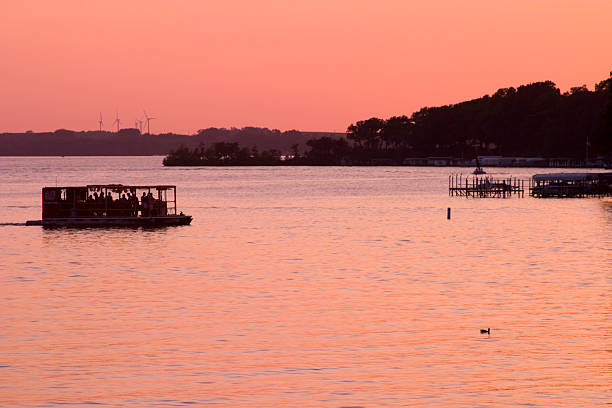 House boat on West Okoboji Iowa in a beautiful Iowa summer sunset.