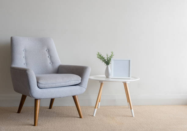 istock Retro armchair with roses and blank frame on table against wall 913880548