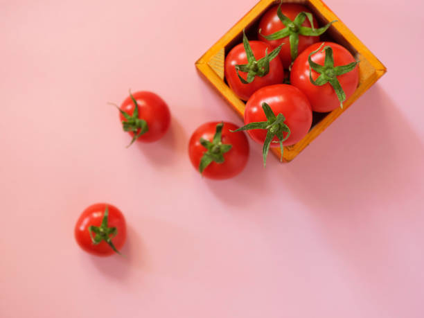 istock Tomatoes spilling out from wooden case 913880640