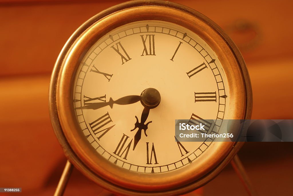 Small desktop clock with roman numerals  Alloy Stock Photo